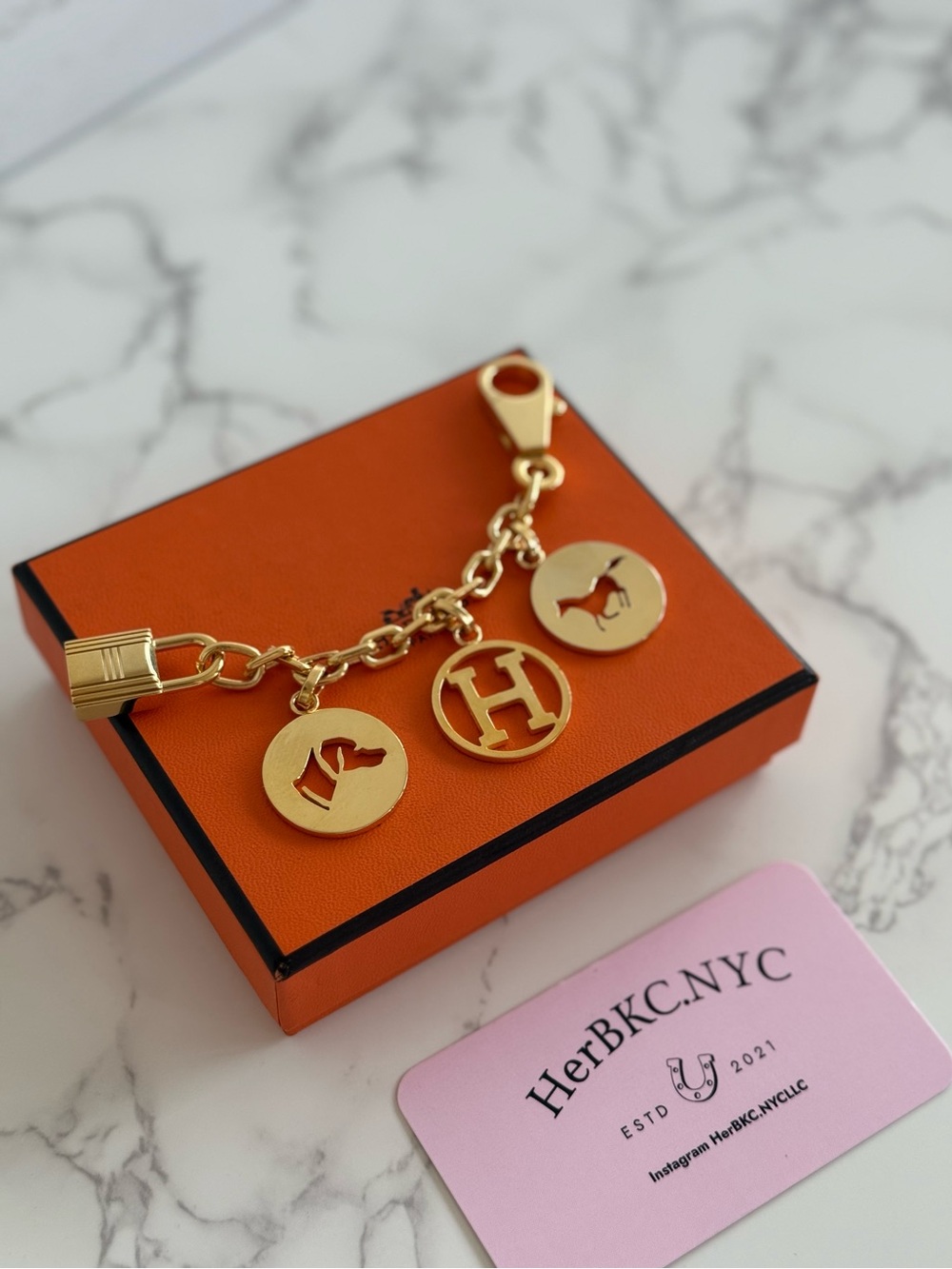 Hermes Gold-Tone Pendant Key & Card Holder on Orange Box